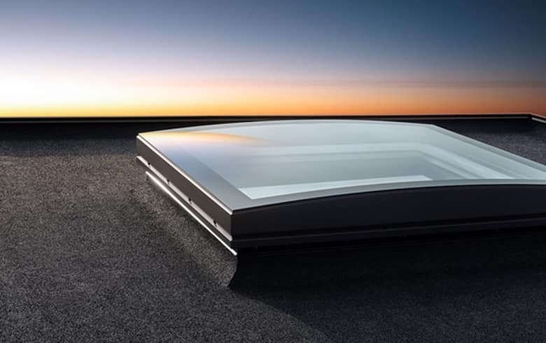 Premium Velux skylight on flat roof with sunset